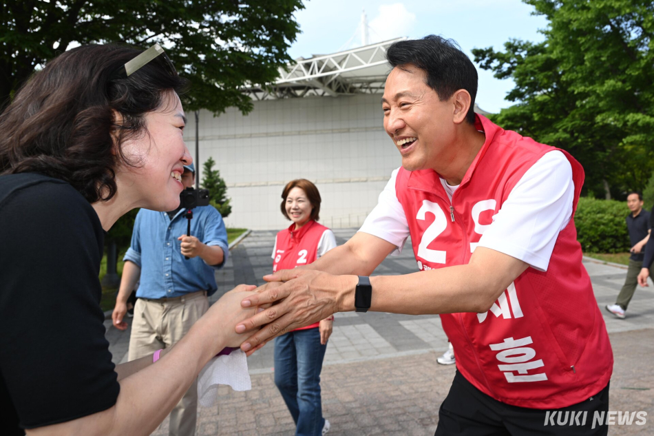 오세훈 국민의힘 서울시장 후보가 25일 서울 광진구 서울어린이대공원에서 지지자와 인사를 나누고 있다.