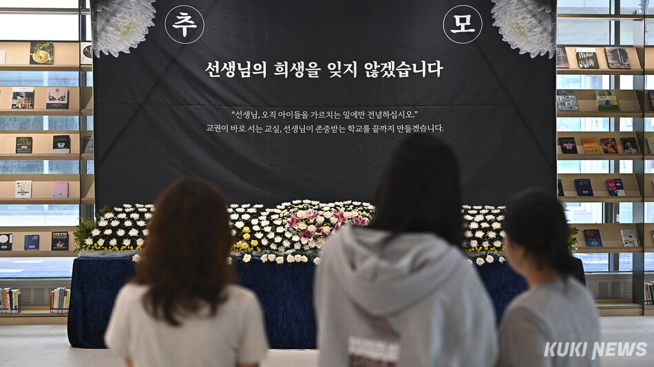 13일 경기도 수원시 경기도교육청 남부청사를 찾은 시민들이 순직 교사 추모공간을 바라보고 있다.